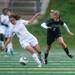 Skyline's Margo Apostoleris dribbles ball up field as Huron's Maggie Hannaford goes after the ball during the first half of their game, Thursday May 23.
Courtney Sacco I AnnArbor.com 